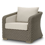 Silla de exterior Bryson de ratán sintético tejido en color arena viola