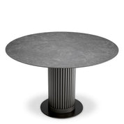 Mesa de comedor exterior Volterra redonda de cerámica gris con acabado bronce