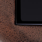 Mesa auxiliar Quentin de cristal negro con aspecto oxidado